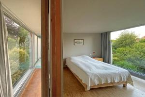 Ένα ή περισσότερα κρεβάτια σε δωμάτιο στο Maison Quatre Saisons