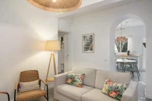 a living room with a couch and a table at Barlavento by An Island Apart in Porto Santo