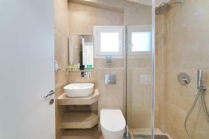 a bathroom with a shower and a toilet and a sink at INROY SEA VIEW APARTMENTS in Skala Potamias +77 photos
