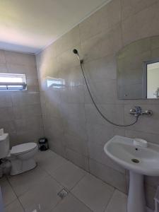 a bathroom with a shower and a toilet and a sink at Nino apartments in Ureki +12 photos