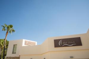 a building with a sign that reads evil play at Apartamentos Azul Playa in Cala d´Or +47 photos