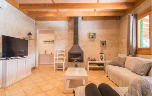 a living room with a couch and a fireplace at Sa Sargantana in Llucmajor