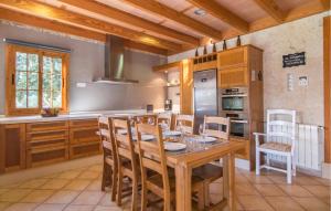 a kitchen with a wooden table and chairs in a room at Sa Sargantana in Llucmajor