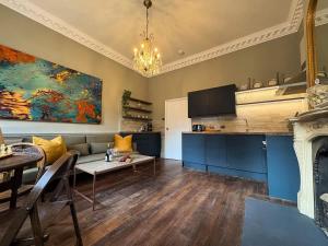 a living room with a couch and a table at Bijou Beauty - Bath Abbey in Bath