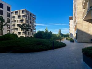 a brick walkway between two buildings with a park at Cozy Cloche Nest - Studio in Luxembourg