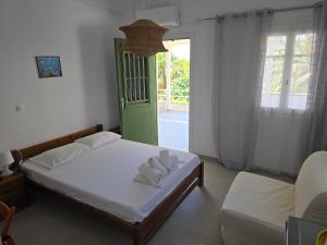 a bedroom with a bed with towels on it at Oasis in Kamares