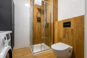 a bathroom with a shower and a toilet at Apartament Żeńców, Bemowo, Free Parking in Warsaw +13 photos