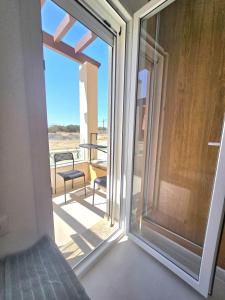 a sliding glass door with a view of a balcony at Appartement mirador golf 3 in Cabo Negro