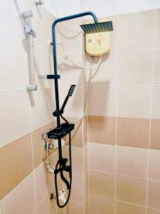 a stand up shower in a bathroom with a hair dryer at The Birrells Boracay by Cassy in Boracay +22 photos