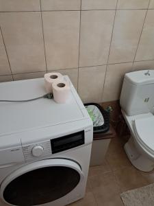 a washing machine with two rolls of toilet paper on it at Epanomi apartment in Epanomi