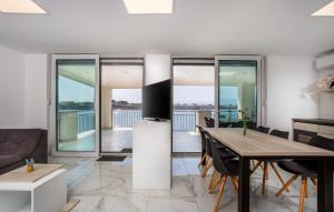a living room with a table and a television at Villa Nada sea view&whirpool island Krk by Villas in Omišalj