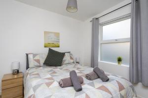 a bedroom with a bed with two pillows on it at Albert Lodge in Belfast