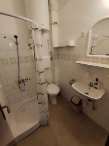 a bathroom with a toilet and a sink at Apartmani Vučević in Sutomore +33 photos