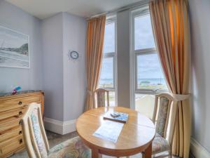 a dining room with a table and a window at Apartment 2 - 1 Bedroom Sea Front-Sea Views-Free Parking in Paignton