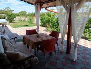 a patio with a table and chairs on a patio at Casa Anna in Tăşnad