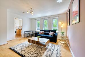 una sala de estar con un sofá y una mesa en 2BR City Flat Walk to Buchanan Hydro with Parking, en Glasgow