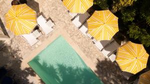 an overhead view of a swimming pool with umbrellas at Hôtel Le Sud in Juan-les-Pins