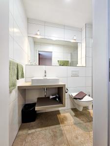 a bathroom with a sink and a toilet at Gasthof Geier in Wörth an der Donau