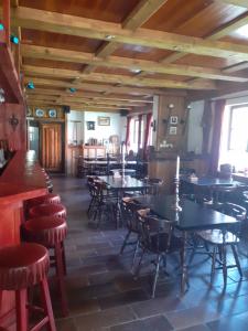 a restaurant with tables and chairs in a room at Kratochviluv mlyn in Červená Lhota