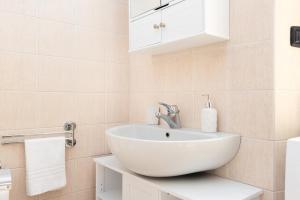 a bathroom with a white sink and a white cabinet at BGY Airport 10Min Casa Moderna con Ampio Balcone in Bergamo +23 photos