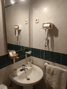 a bathroom with a sink and a mirror at Hostal Puerta Medina in Sigüenza +29 photos
