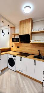 a kitchen with a sink and a washing machine at Bamboo Beach Tsikhisdziri 347K in Tsikhisdziri