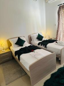 two beds sitting in a room withskirts at Couple's Getaway in Is-Swieqi