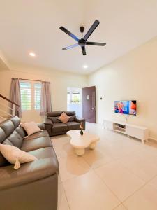 a living room with a couch and a ceiling fan at Golden Sweet Home @ CH Golden Hills (Night Market) in Cameron Highlands