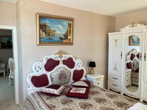 a bedroom with a bed and a painting on the wall at Апартамент в КК "Елените" с фронтална гледка море, разположен на самия плаж in Sveti Vlas +19 photos