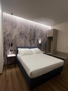 Postel nebo postele na pokoji v ubytování Hotel La Rocca