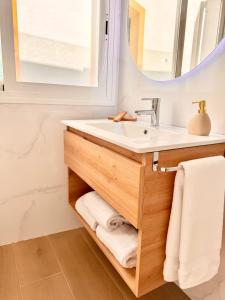 a bathroom with a sink and a mirror at Apartamentos Ana Marbella centro in Marbella