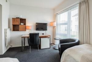 TV a/nebo společenská místnost v ubytování Golf Hotel Viborg