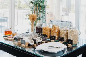 a glass table with jars of food on it at Velamar Boutique Hotel - Adults Friendly in Albufeira