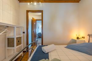 a bedroom with a bed and a hallway at ROMANTIC COMO HIDEAWAY with private parking and AirCon in Acquaseria