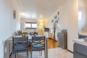 a kitchen and dining room with a table and chairs at ROMANTIC COMO HIDEAWAY with private parking and AirCon in Acquaseria
