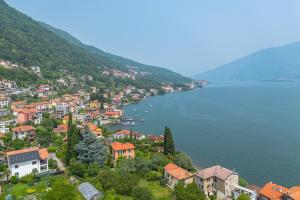 a town on a hill next to a body of water at ROMANTIC COMO HIDEAWAY with private parking and AirCon in Acquaseria
