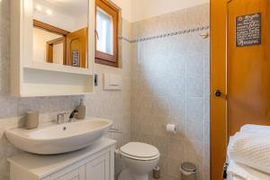 a bathroom with a sink and a toilet and a mirror at ROMANTIC COMO HIDEAWAY with private parking and AirCon in Acquaseria +20 photos