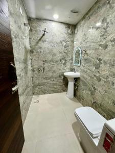 a bathroom with a toilet and a sink at Hotel Basant in Amritsar