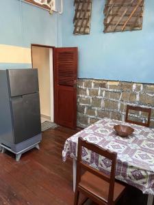 a room with a table with a bowl on it and a television at Studio Ylang - Vue mer & détente à Nosy Be in Nosy Be +7 photos