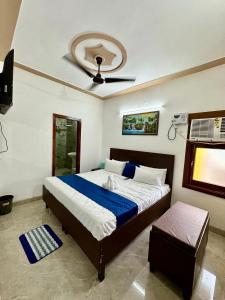 a bedroom with a large bed and a fan at Hotel Basant in Amritsar