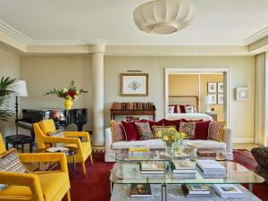 a living room with a couch and a table at Rocco Forte The Charles Hotel in Munich