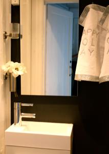 a bathroom with a sink and a mirror and a towel at Home sweet home CPH in Copenhagen