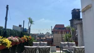 a group of chairs sitting on a balcony at Hostel Inn Downtown in Belgrade