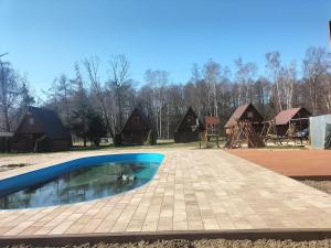a swimming pool in front of a group of houses at KANZAS in Jarosławiec