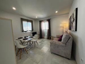 een woonkamer met een bank en een tafel bij CONIL CENTRO MERCURIO solo FAMILIAS in Conil de la Frontera