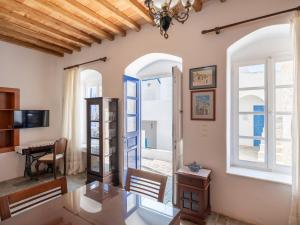 a living room with a table and a window at Marouso Villa - Paros Seaview Getaway in Márpissa