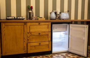 a kitchen with a counter with an open refrigerator at Mqabba Studio Flat by Talbot & Bons in Mqabba