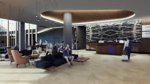 a group of people sitting on a couch in a lobby at Novotel Zagreb in Zagreb