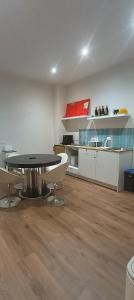 a living room with a table and a kitchen at Esperia Maison B&b in Montesarchio