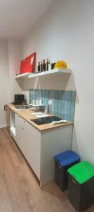 a kitchen with a sink and a counter with two stools at Esperia Maison B&b in Montesarchio +9 photos